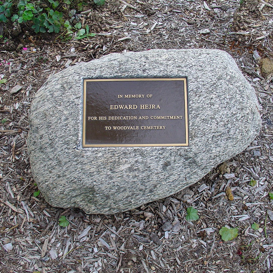 A natural granite boulder memorial with a polished lettering face