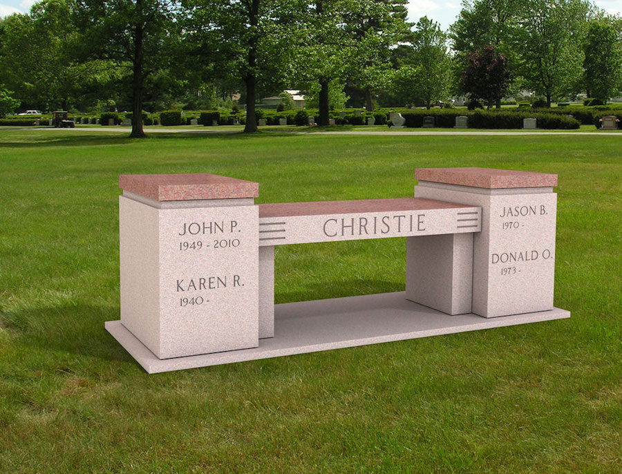 A granite memorial bench with a recessed urn compartment